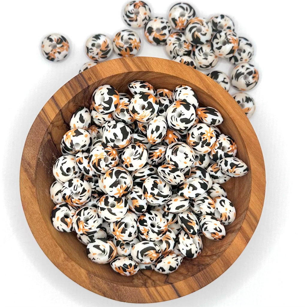 Burnt orange daisy cow print (HBK exclusive) 12mm lentil silicone bead